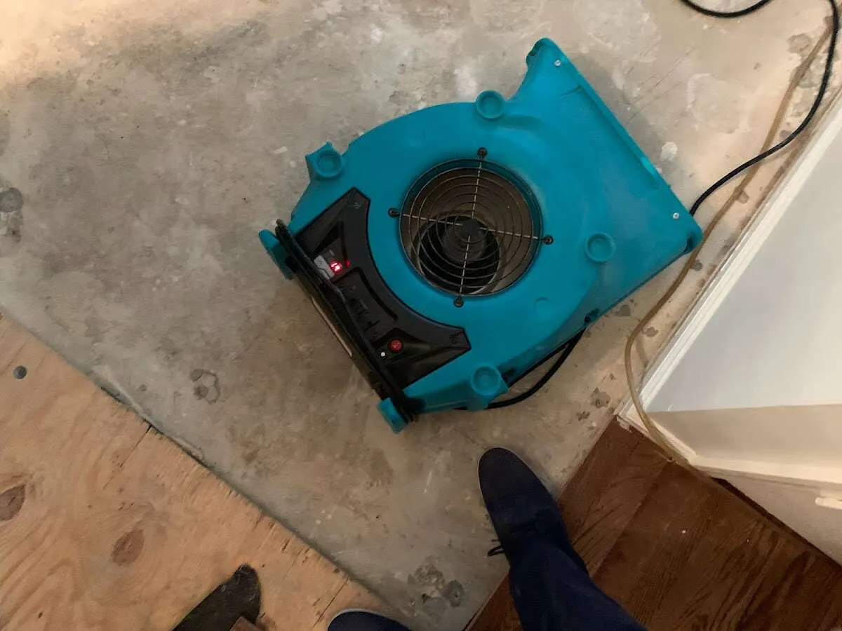 Air mover drying subfloor during Commercial Water Damage Restoration in Dale City